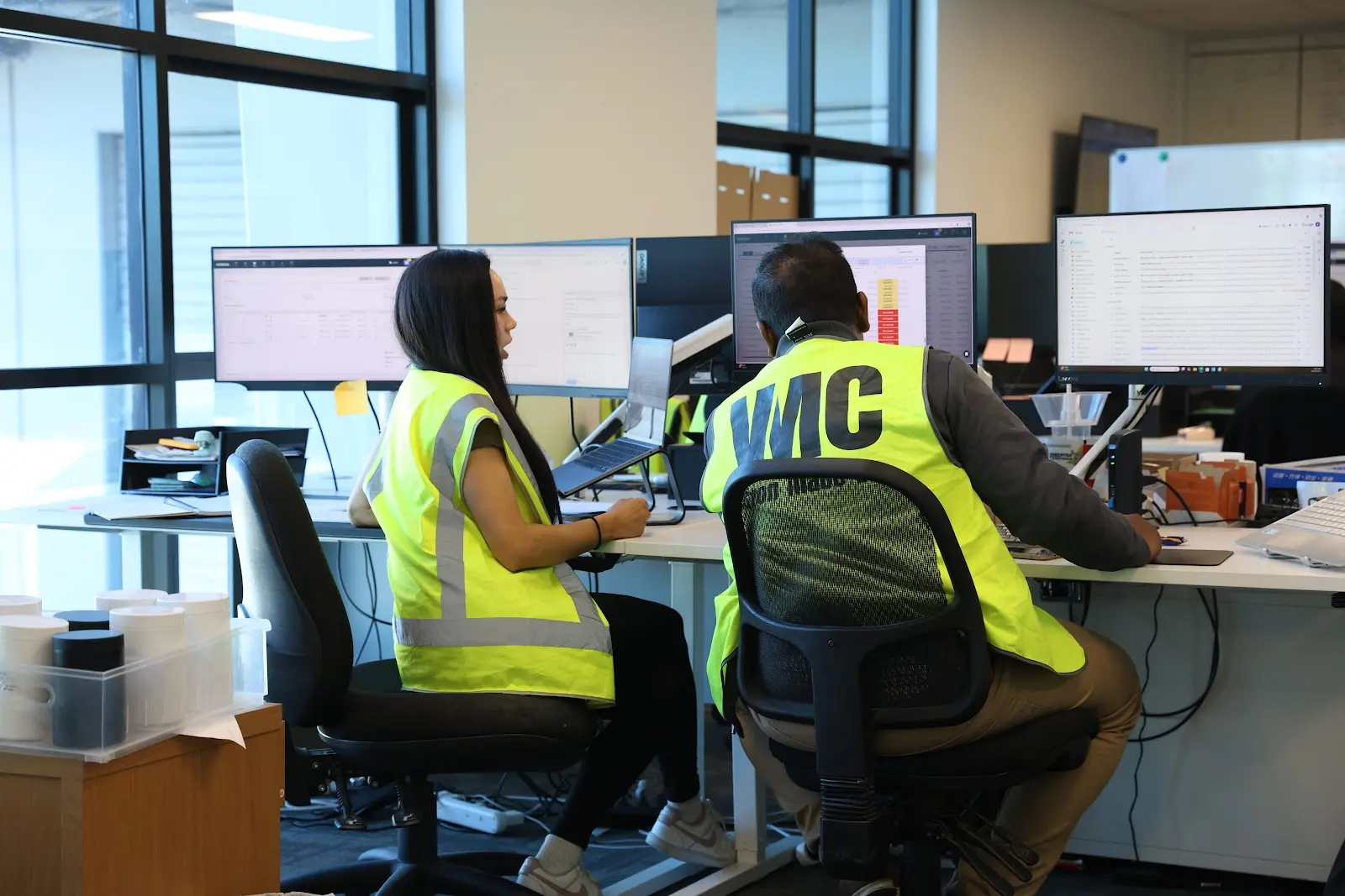 Team members collaborating in high-visibility vests